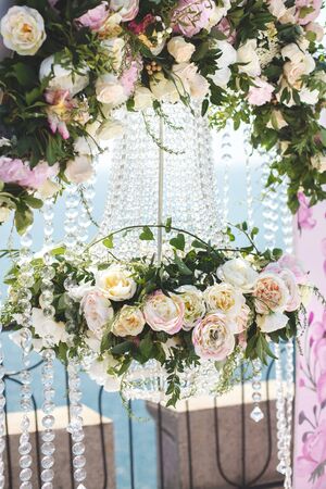 Wedding arch pink color with chandelier and flowersの写真素材