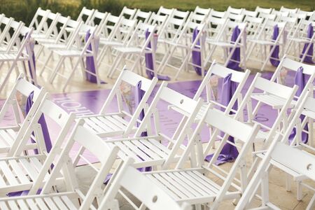 White wooden chairs for wedding ceremony. Flowers roses. Packageの写真素材