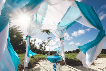 Beautiful white wedding arch for the ceremony on the ocean.の写真素材