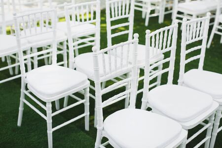 Beautiful white wedding chairs at the ceremony in the Parkの写真素材