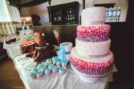 Wedding cake with cupcakes at the exhibition