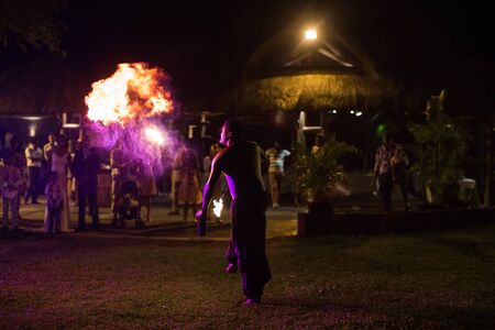 Fire show artist breathe fire in the dark