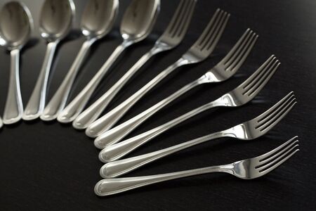 Cutlery on a black background. Fork, spoon, knife.