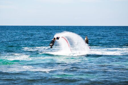 Silhouette of a fly board rider at seaの写真素材