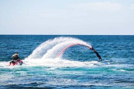 Silhouette of a fly board rider at seaの写真素材