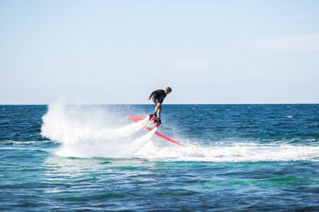 Silhouette of a fly board rider at sea.の写真素材