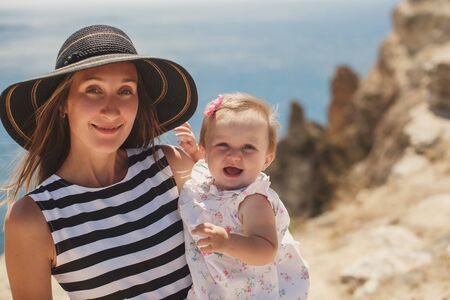 Beautiful mother and daughter on the mountain.