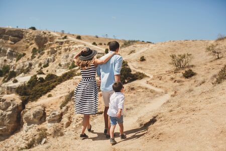 Happy family of four walking in the mountains. Family concept. Family tripの写真素材