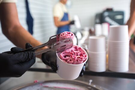 Stir-fried ice cream rolls at freeze pan. Rolled ice cream, hand made ice cream dessert. Fried ice...