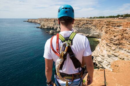 Rope jumping off a cliff with a rope in the water. The ocean. Sea. Mountain