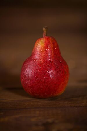 Pear red color on wooden background. healthy food. vitaminsの写真素材