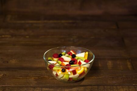 Delicious fruits salad in plate on table close-upの写真素材