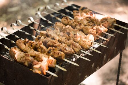 Marinated shashlik preparing on a barbecue grill over charcoal. Shashlik or Shish kebab popular in Eastern Europe. Shashlyk was originally made of lambの写真素材