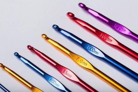 Colored hooks for wool knitting on white backgroundの写真素材