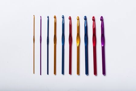 Colored hooks for wool knitting on white backgroundの写真素材