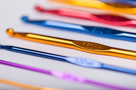 Colored hooks for wool knitting on white backgroundの写真素材