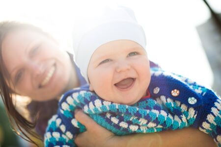 Portrait of smiling mother and baby outdoors