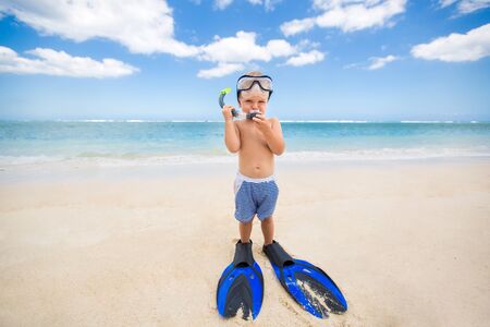 Little boy with diving mask and fins go swim at beachの写真素材
