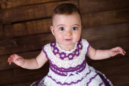 Beautiful girl in pink dress on a wooden background.の写真素材