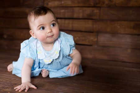 Beautiful girl in blue dress on wooden background.の写真素材