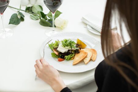 Romantic dinner in the restaurant. Dish on the table with a white tablecloth.の写真素材