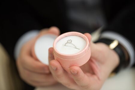 Man making marriage proposal to girlfriend at restaurant, closeup.の写真素材