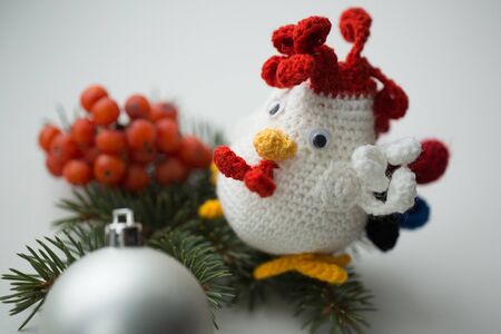 Handmade rooster with fir branches and cranberry.