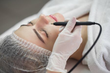 Ultrasound cavitation, face skin cleansing. Macro close up portrait of womanの写真素材