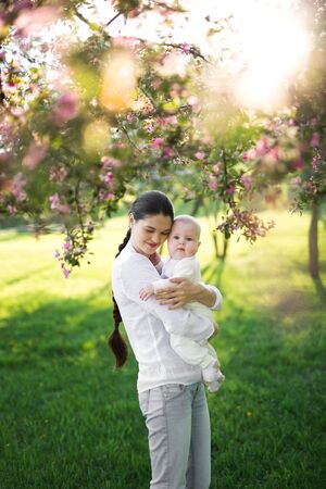 Portrait Beautiful Mother And Baby outdoors. Nature. Beauty Mum and her Child playing in Park.の写真素材