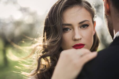 Bride and groom in the green forest.の写真素材