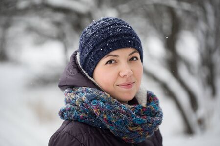 Portrait of a girl in a winter forest close-up.