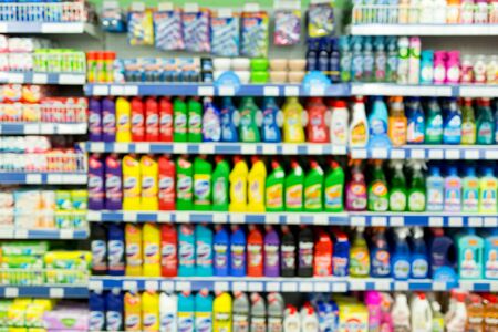Display with many different brands of washing liquids and powder in a supermarket. Blurの写真素材