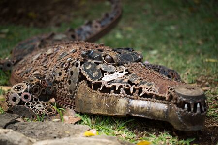 Statue of a crocodile made of metal, gears.の写真素材