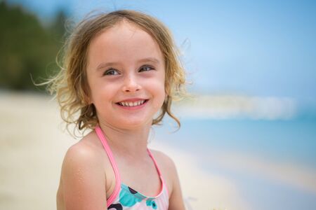 Portrait of adorable little girl at beach during summer vacation.の写真素材