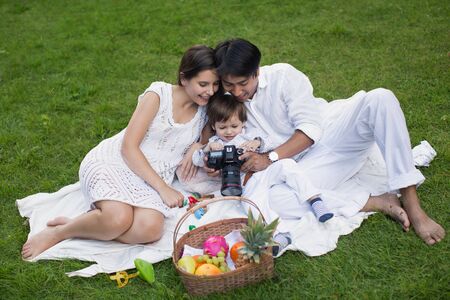 Family picnic in the Park on the green grass.の写真素材