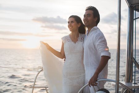 Just married couple on yacht. Happy bride and groom.