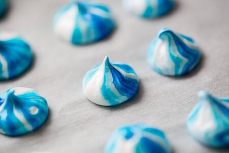 Meringue-a dessert white and blue color. Cooking processの写真素材