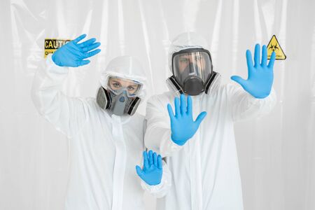 Portrait of two doctors a man and a woman in medical uniform with a protective face mask and a...