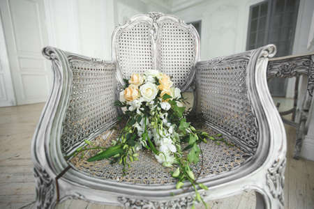 Wedding bouquet lying on a chair in a white Studio.の写真素材