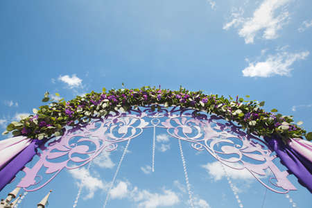 Wedding arch of purple color on the background of the seaの写真素材