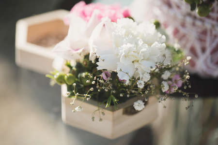 Wedding rings and a composition of fresh flowers on the registration tableの写真素材