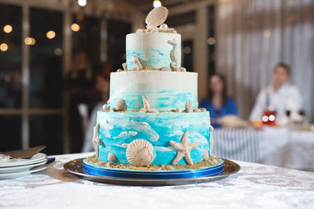 A beautiful wedding cake for newlyweds at a wedding in a nautical style. A birthday cake at a banquetの写真素材