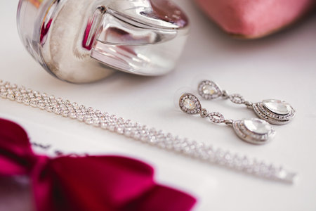 Brides wedding accessories: perfume, earrings, bracelet, bow