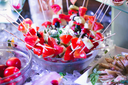 Catering table buffet dinner, beautifully decorated banquet with variety of different food snacks...
