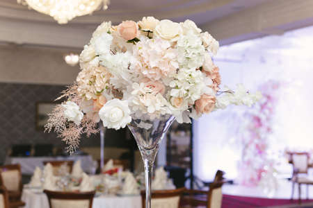 Table setting at a luxury wedding reception. Beautiful flowers on the tableの写真素材