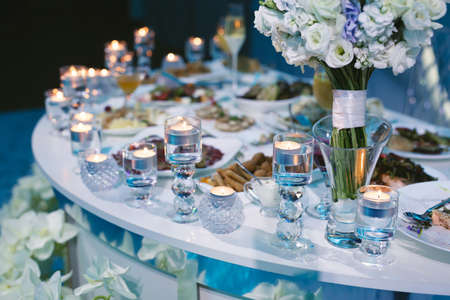 Served wedding banquet table with dishes in the restaurant.