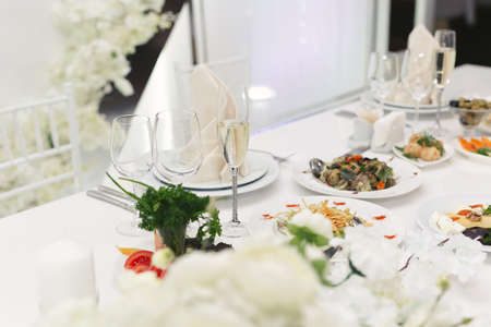 Served wedding banquet table with dishes in the restaurant.の写真素材