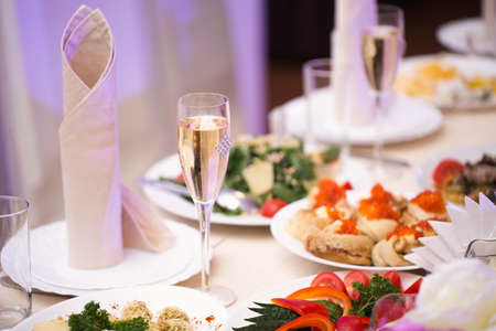 Served wedding banquet table with dishes in the restaurant.の写真素材