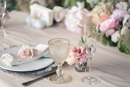 Delicate wedding table setting. A plate with a napkin and a roseの写真素材