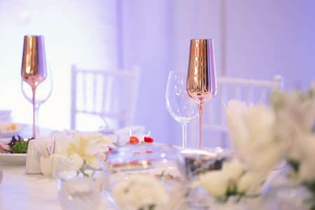 Table at a luxury wedding reception. Beautiful flowers on the table. Serving dishes, glass glasses.の写真素材